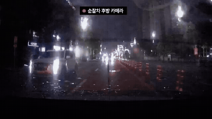 경찰차 바짝 붙어 상향등 ‘깜빡깜빡’…빗길 택시의 정체는