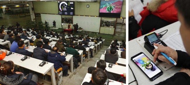 춘란 애호가들이 진지하게 경매에 임하고 있다. [박해윤 기자]