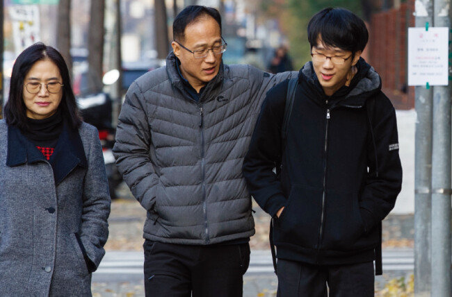 2. 한 학생이 부모님의 응원을 받으며 고사장으로 들어가고 있다. [조영철]
