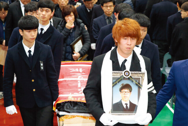 ‘특성화고등학생 권리연합회’ 소속 고등학생 등 참가자들이 2017년 12월 5일 저녁 서울광장 인근 도로에서 고 이민호 군의 마지막 추모제를 열고 있다. [뉴시스]