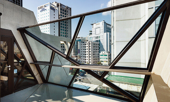 5층에 해당하는 옥상 공간. 쿠킹체험장과 연계해 다용한 용도로 쓸 수 있도록 비워놨다. 1층 출입문의 기하학 무늬를 원용한 커다란 철골 유리창이 눈길을 끈다. [홍태식]