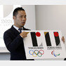 FILE - In this Aug. 5, 2015, file photo, Japanese designer Kenjiro Sano gives a detailed explanation of how he came up with his logo, left, for the 2020 Tokyo Olympics at a press conference in Tokyo. Tokyo Olympic organizers defended Sano in a logo scandal Friday, Aug. 28, 2015, denying allegation his design for the 2020 Games was taken from a Belgian theater. The organizers disclosed Sano？ initially submitted logo, saying its emphasis on ？?shape had no resemblance to that of Theater de Liege and that a circle on the background was added later when his design was touched up. (AP Photo/Ken Aragaki, File)