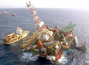 Salvage crews work to raise sinking oil rig