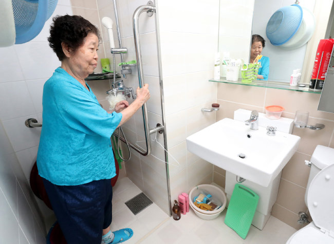 이복순 할머니가 경기 성남시 수정구 위례35단지 자신의 아파트 화장실에 설치된 손잡이를 잡고 서 있다. [최혁중 동아일보 기자]