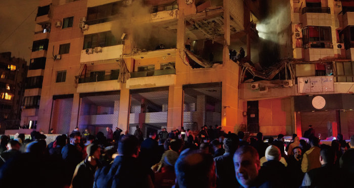 1월 2일 레바논 수도 베이루트의 한 건물에서 대규모 폭발이 발생해 건물 일부가 내려앉은 가운데 시민들이 이 모습을 지켜보고 있다. 이날 이스라엘은 베이루트 일대에 대대적 무인기 공격을 가했고, 베이루트 외곽에 머물던 하마스 고위 간부 살레흐 알 아루리 또한 숨졌다. [AP뉴시스]