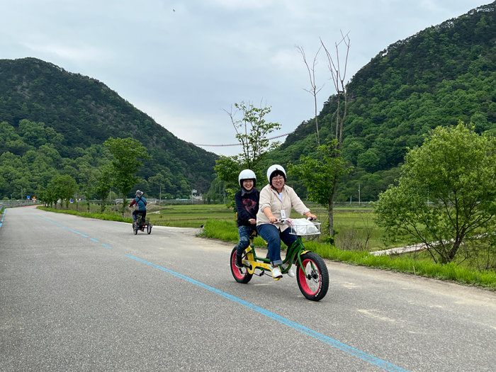 관광객들이 섬진강변을 따라 2인 자전거를 타고 있다. [김지영]
