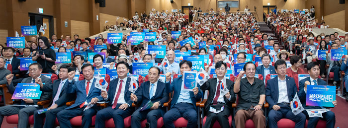 15일 서울 여의도 국회에서 열린 ‘2024 통일실천결의대회’에서 참가자들이 태극기와 단체 피켓을 들고 ‘자유 통일 한반도 실현’의 결의를 하고 있다. [통일을실천하는사람들]