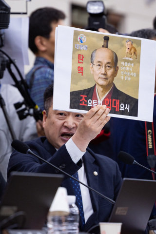 최혁진 무소속 의원이 10월 13일 서울 여의도 국회에서 열린 법제사법위원회의 대법원 등에 대한 국정감사에서 조희대 대법원장과 도요토미 히데요시를 합성한 사진이 그려진 손팻말을 들어 보이고 있다. 뉴스1