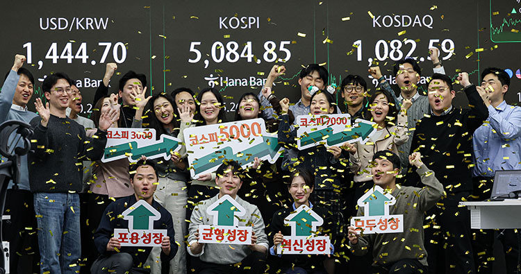 코스피가 종가 기준 사상 처음으로 5000선을 돌파한 1월 27일 오후 서울 중구 하나은행 본점 딜링룸에서 직원들이 축하 세리머니를 하고 있다. 동아DB