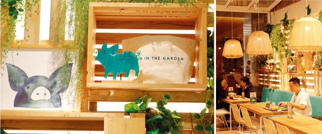 




매장 곳곳에 그려진 초록 돼지의 표정이 평화롭게 느껴진다(왼쪽). ‘피그인더가든’에서 식사를 하고 있는 직장인들의 모습. [박해윤 기자]