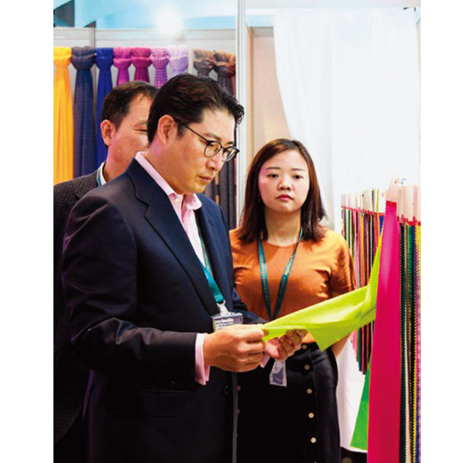 2018년 조현준 효성 회장(가운데)이 중국 상해에서 열린 글로벌 섬유전시회에 참석해 제품을 보고 있다. [사진 제공 · 효성티앤씨]
