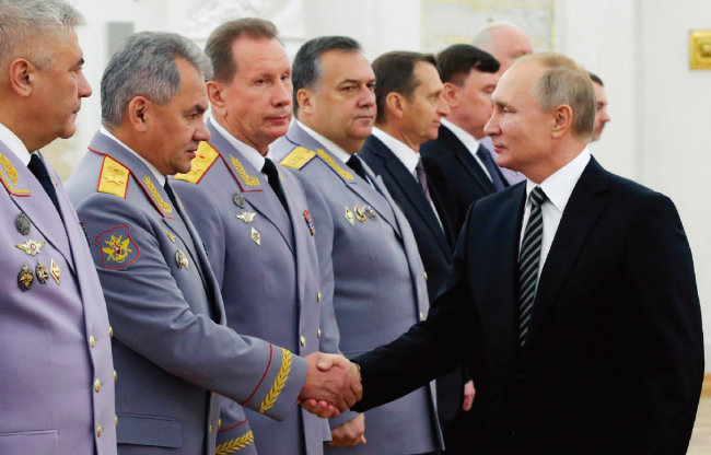 블라디미르 푸틴 러시아 대통령(오른쪽)이 모스크바 크렘림궁에서 세르게이 쇼이구 국방장관과 악수하고 있다. [크렘린궁 제공]