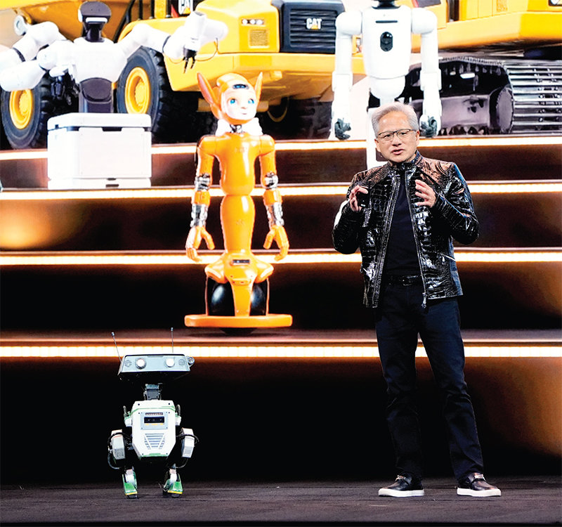젠슨 황 엔비디아 최고경영자(CEO)가 1월 5일 미국 라스베이거스에서 진행된 CES 2026 기조연설에서 엔비디아의 소형 컴퓨터 ‘젯슨(Jetson)’이 탑재된 로봇과 대화하고 있다. 뉴시스 
