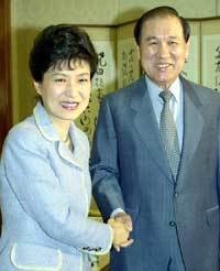 노 전대통령과 박근혜부총재가반갑게 악수하고 있다.