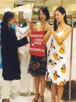 도우미가 올 여름 유행할 의류를 입어보고 있다