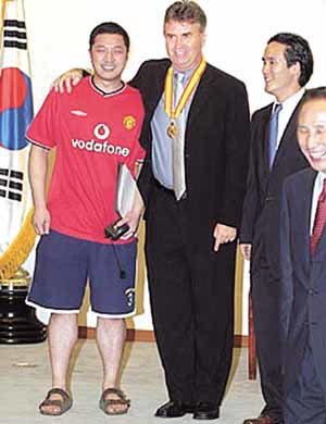 이명박 시장의 아들(왼쪽)과 사위(오른쪽에서 두번째)가 히딩크 감독과 나란히 서서 웃고 있는 사진. - 서울시 홈페이지