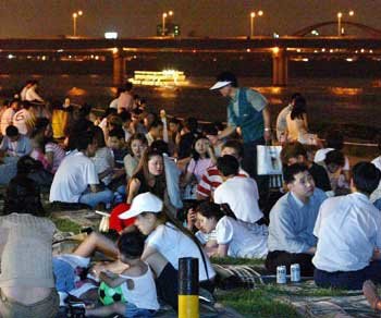 여름밤의 더위로 잠 못 이루는 시민들이 한강둔치에서 돗자리를 깔고 밤참을 즐기고 있다. 스트레스 해소 등을 위해 습관적으로 밤참을 먹는 것은 문제가 된다. 동아일보 자료사진