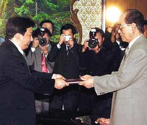 24일 평양 만수대의사당에서 김영남 최고인민회의 상임위원장(오른쪽)이 양빈 신의주특별행정구 장관에게 임명장을 주고 있다. - 조선신보연합