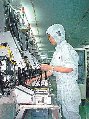 완벽한 제품 꿈꾸며…SKC 중국 푸저우공장의 한 여성 근로자가 비디오 테이프 내부에 들어가는 마그네틱 테이프를 손으로 감고 있다. 사진제공 SKC