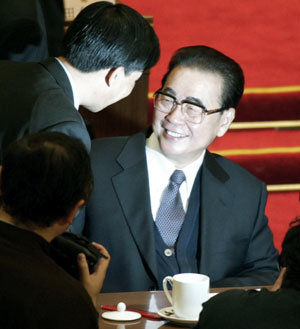 리펑(李鵬·가운데) 중국 전국인민대표대회 상무위원장이 공식 은퇴에 앞서 10일 전인대 회의에서 마지막 공작보고를 마친 뒤  젊은 대표들의 인사를 받고 있다. -베이징〓AP 연합