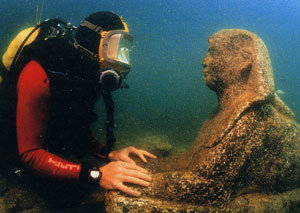 알렉산드리아 앞 바다의 해저에서 스핑크스를 찾아낸 발굴조사팀원이 마치 수천년의 세월을 뛰어넘어 스핑크스와 대화하는 것처럼 살펴보고 있다. -사진제공 이집트 해저유적탐사국