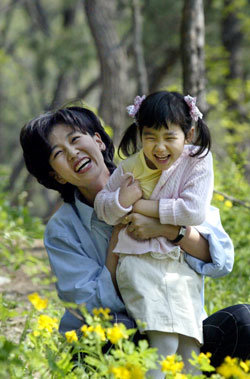 1일 한의사 김소형씨가 서울 종로구 구기동 북한산 등산로 주변의 꽃길에서 딸과 함께 환하게 웃고 있다. -김미옥기자