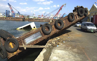 태풍 ‘매미’가 지나간 지 거의 한달이 된 9일 부산 영도구 봉래동 보세창고 앞 해안에 바지선 한 척이 여전히 방치되어 있어 지나는 차량들을 위협하고 있다. -부산=최재호기자