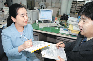 “신고접수 이렇게”26일부터 서울 강남구 등 4개 지역에서 ‘주택거래신고제’가 실시되면서 행정 담당자들도 바빠졌다. 강남구청 지적과 토지관리팀 나승일 팀장(오른쪽)이 이날 일원1동사무소를 찾아가 주택거래신고 담당자에게 신고 방법을 설명하고 있다. 김미옥기자