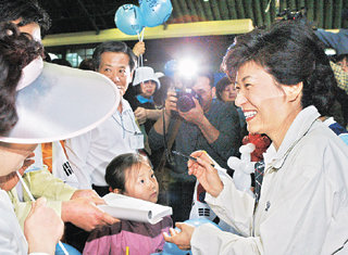한나라당 박근혜 대표가 2일 서울 서초구 양재동 시민의 숲에서 열린 걷기 행사에 참석해 지지자들에게 사인을 해주고 있다. ‘박근혜를 사랑하는 사람들의 모임’ 등이 공동 주최한 이날 행사에서 박 대표는 지지자들과 대중가요를 함께 부르며 여흥의 시간을 갖기도 했다. -서영수기자