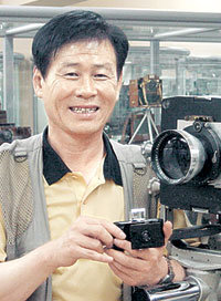 1950년대 독일 린호프사에서 만든 대형 카메라 앞에서 포즈를 취한 카메라 컬렉터 김종세씨.-허문명기자