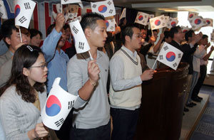 24일 오전 서울 중구 한국프레스센터에서 보수성향의 50여개 청년단체 회원들이 기자회견을 열고 ‘국가보안법 사수’ 등을 주장하는 시국선언문을 발표한 뒤 태극기를 흔들며 구호를 외치고 있다. -연합