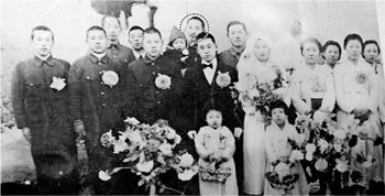 점선 안의 남자가 김일련 씨한나라당 ‘김희선 의원 선친 친일행적 진상규명 조사단’이 공개한 김일련 씨(점선 안) 사진. 이 사진은 1944년 중국에서 김 씨의 남동생(앞줄 가운데 나비넥타이를 맨 이) 결혼식 때 찍은 것으로 김 씨가 안고 있는 아이는 김 의원의 오빠라고 조사단은 밝혔다. 사진 제공 한나라당