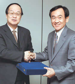본사 어경택 상임고문(오른쪽)이 31일 김학준 사장에게서 정년퇴임을 기념하는 감사패를 받고 있다.
