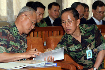 “뭐라고 답변하지?” 6일 국회 국방위원회에 출석한 이성규 합참 정보본부장(왼쪽)과 김태영 합참 작전본부장이 북한의 미사일 발사에 대한 군당국의 대응과정을 따지는 의원들의 질의에 답변하기 위해 서류를 확인해 가며 의논하고 있다. 이종승 기자