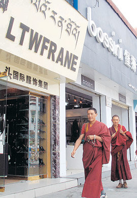 라싸 시내에 줄줄이 늘어선 외국 제품 상점 간판과 라마 승려의 티베트 전통 승복이 묘한 대조를 이루고 있다.