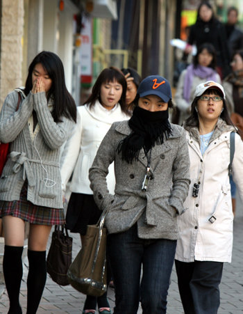 간밤에 첫눈이 내린 뒤 서울 광교로 출근하거나 등교하는  이화여대 앞 학생들의 겨울 옷이 두꺼워졌다. 이훈구기자