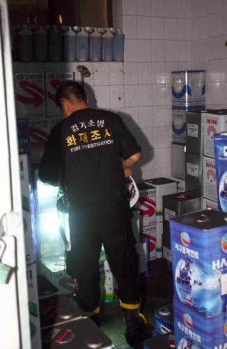 9일밤 화재로 6명이 사망한 경기도 의왕시 고천동 화장품 케이스공장에 출동한 소방관들이 화공약품이 가득 찬 창고를 확인하고 있다. [연합]