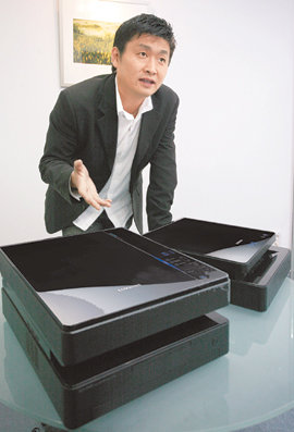 세계에서 가장 얇은 흑백 레이저 프린터인 ‘스완’(오른쪽)과 복합기 ‘로간’을 디자인한 삼성전자의 배준원 책임디자이너. 스완의 두께는 12cm, 로간은 16.5cm로 기존 동급 제품의 3분의 2 정도에 불과하다. 사진 제공 삼성전자