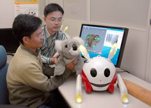 ETRI(한국전자통신연구원) 연구원들이 개발한 감성로봇`코비'(KOBIE.왼쪽)와`래비'(RABIE)를 시연해 보이고 있다.[ETRI 제공]