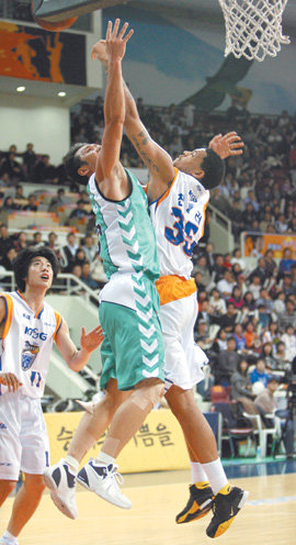 동부 손규완(왼쪽)이 KT&G 마퀸 챈들러가 막아선 가운데 레이업 슛을 시도하고 있다. 손규완은 4쿼터에만 3점슛 2개를 포함해 10점을 넣으며 팀 승리를 이끌었다. 안양=연합뉴스