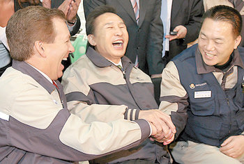 이명박 대통령 당선인(가운데)이 29일 오후 인천 GM대우자동차 부평공장을 방문해 공장을 둘러본 뒤 마이클 그리말디 사장(왼쪽)과 이남묵 노조위원장의 손을 감싸 잡으며 크게 웃고 있다. 사진공동취재단