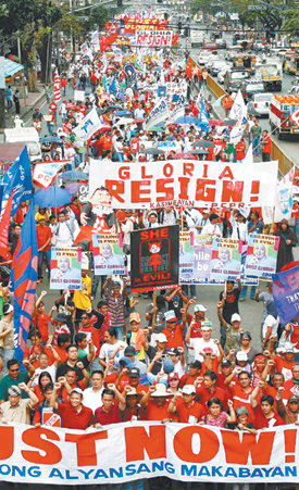 “아로요 퇴진하라”25일 독재자 마르코스 대통령을 몰아낸 ‘피플파워’ 22주년을 맞아 필리핀 마닐라에서 수천 명의 시위 참가자가 부패 혐의를 받고 있는 글로리아 아로요 대통령의 퇴진을 촉구하며 시내를 행진하고 있다. 마닐라=로이터 연합뉴스