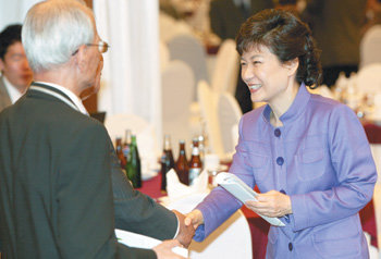박근혜 전 한나라당 대표(오른쪽)가 26일 대안교과서 출판기념회에서 참석자들과 악수하고 있다. 연합뉴스