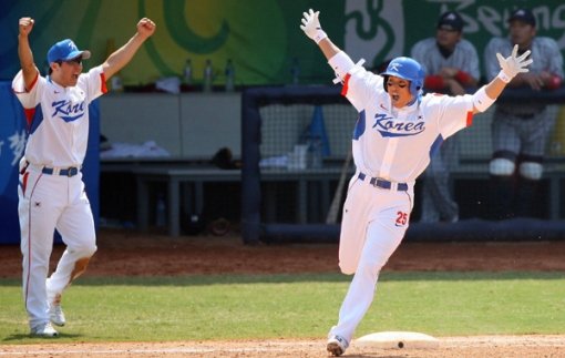 이승엽(오른쪽)이 일본과의 준결승 8회말 결승 역전 투런 홈런을 친 뒤 베이스를 돌며 환호하고 있다. 왼쪽은 1루 베이스 코치로 나선 박진만. 연합뉴스