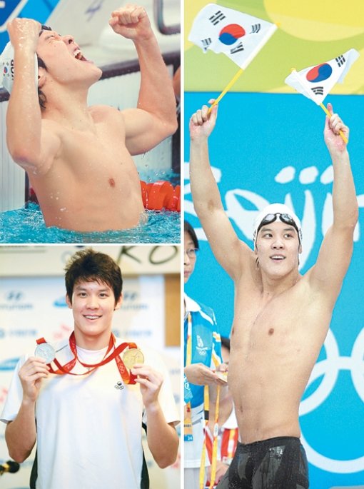 10일 한국 수영 사상 처음으로 남자 자유형 400m에서 금메달을 확정지은 박태환이 관중으로부터 건네받은 태극기를 흔들며 기뻐하고 있다. 동아일보 자료 사진