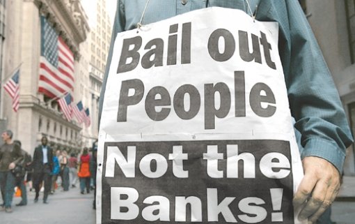 “은행 아닌 국민 구제하라”미국 하원의 구제금융법안 표결에 앞서 토론이 진행 중이던 지난달 29일 뉴욕증권거래소 앞에서 한 시민이 ‘은행이 아니라 국민을 구제하라’는 내용의 피켓을 목에 걸고 시위하고 있다. 뉴욕=로이터 연합뉴스