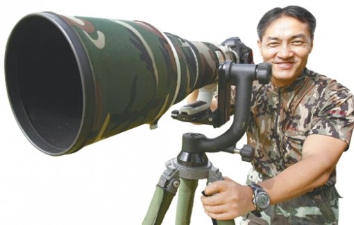 장성일 씨가 조류 사진을 찍기 위해 사진기를 설치한 후 위장복(군복)을 입은 채 기다리고 있다. 김재명 기자