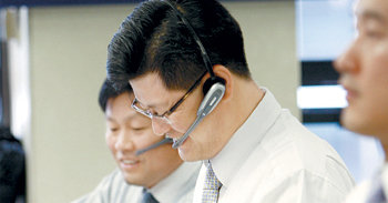 서울 중구 외환은행 본점에서 한 외환딜러가 환율이 떨어지는 모습을 보며 환한 표정을 짓고 있다. 변영욱 기자