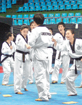 ‘춤추며 연기하는 태권도.’ 태권도 시범단원들이 30일 서울 강남구 역삼동 국기원에서 태권도와 뮤지컬을 결합한 새로운 형태의 퍼포먼스를 선보였다. 남자 주인공(가운데)이 태권도를 배워 건달들을 물리친 뒤 동료들의 환영을 받고 있다. 사진 제공 국기원