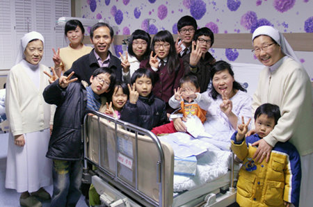 3일 충북 청주성모병원에서 열째 아이를 낳은 이재순 씨(침대에 앉은 이)가 가족과 병원 관계자들의 축하를 받고 있다. 사진 제공 청주성모병원